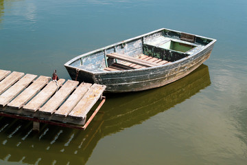 Fototapeta premium An old wooden boat in the river near