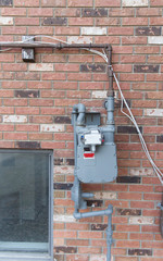 gas meter against a brick background