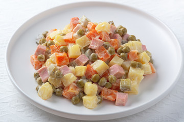 Russian traditional salad Olivier with vegetables and meat...