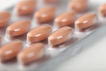 Pills capsule in plastic strip on white background. Antibiotics, vitamins, painkiller.