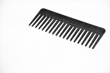 black comb with hair and dandruff