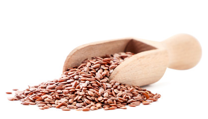 Flax seeds in a wooden spatula on a white background. Isolated