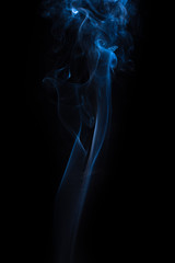 The movement of the smoke on a black background .