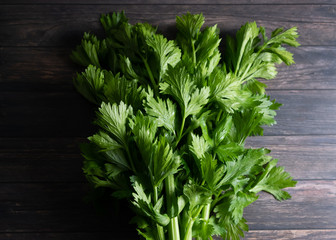 Celery leaves detail on wooden background