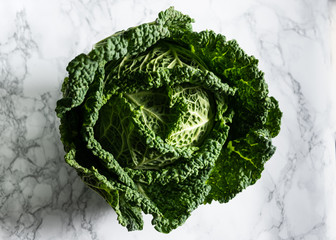 savoy cabbage on white marble background