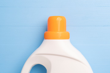 White plastic bottle with a bright orange cap with liquid washing powder or bleach and fabric softener