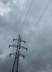 Electric wires on the gray sky background