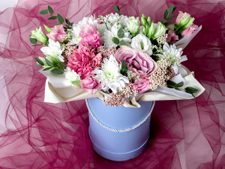 flowers in a box with red tulle