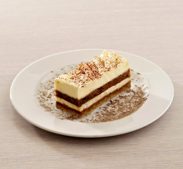 Chocolate cake with cream on white plate