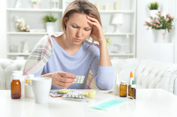 Portrait of beautiful young woman with pills