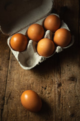 packaging of six eggs on wooden table