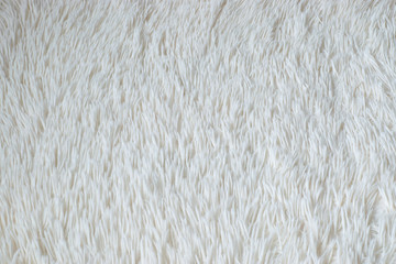 White shaggy blanket texture as background. Fluffy fake textile fur.