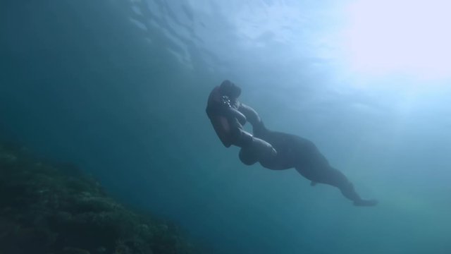 Underwater shoot of young guy snorkeling in tropical sea.
