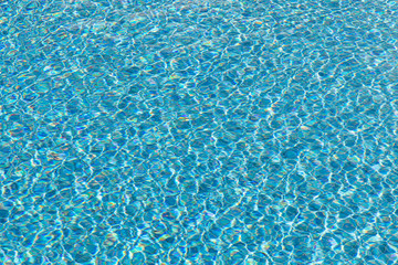 Fototapeta na wymiar background of blue small tiles at a swimming pool with water structure