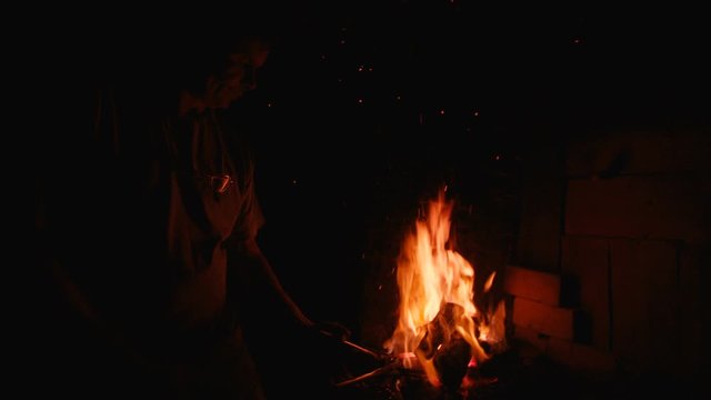 A blacksmith forging horseshoes for horses