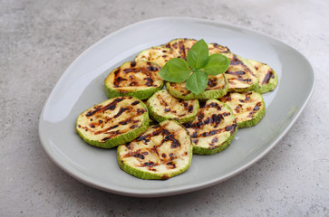 zucchini cut into slices and grilled fried. Decorated with a basil.