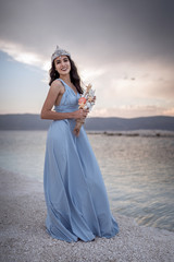 Fototapeta na wymiar Gothic woman in a blue dress on the edge of Salda Lake