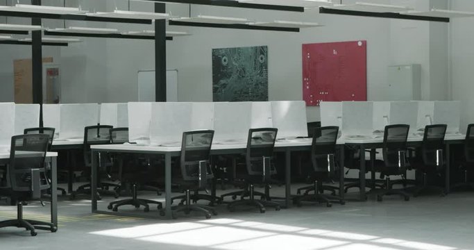 Modern empty coworking space with covered computers