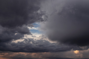 Fototapeta na wymiar Epic Dramatic Storm sky, dark grey clouds against blue sky background texture, thunderstorm
