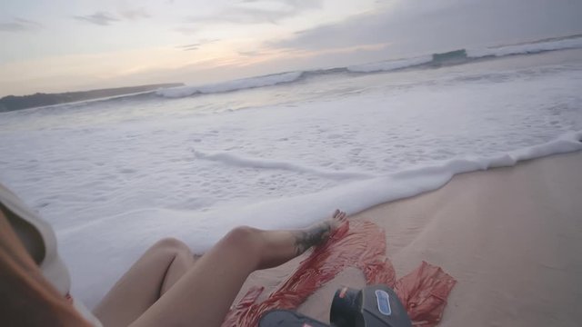 Girl after snorkeling with seabob relaxing on sandy shore