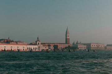 Fototapeta premium The beautiful, sunny streets of Venice, ancient buildings, canals and roofs