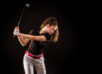Girl looking for the perfect golf shot isolated on black background	