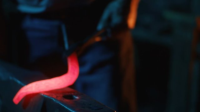 A blacksmith forging horseshoes for horses