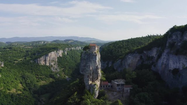 Katskhi pillar. Alone man's monastery near the village of Katskhi. The orthodox church and the abbot cell on a rocky cliff. Imereti, Georgia.