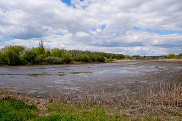 Empty and drained pond. Drought and no water in the landscape.