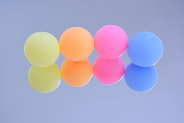 Ping pong balls on a mirror. 