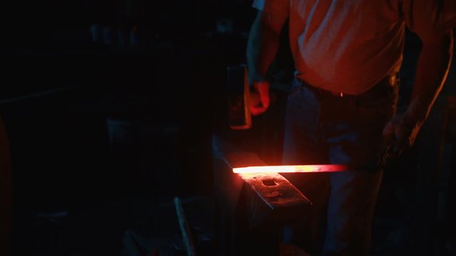 A blacksmith forging horseshoes for horses
