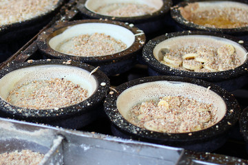 Traditional Malaysian street food apam balik - thick soft pancake with peanuts, bananas, peanut butter and sweet corn. Street market in Georgetown, Malaysia.