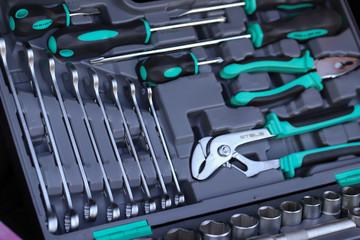 there are tools in the drawer, neatly arranged in their proper places, neat new tools for the machine