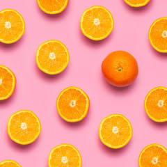 Fototapeta na wymiar Fruit pattern, creative summer concept. Fresh juicy whole and sliced orange on pink background. Flat lay Top view. Minimalistic background with citrus fruits, vitamin C. Pop art design Banner