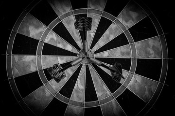 Dartboard with Three Darts in the Bull's Eye - Black and White