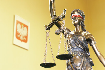 Symbol of law - Themis and Polish national emblem, shallow depth of field, focus on Themis statue