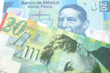 A close up image of a blue, twenty Mexican peso bank note with a twenty shekel note from Israel