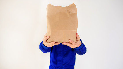 Close up hands of a courier that holding a eco paper bag.