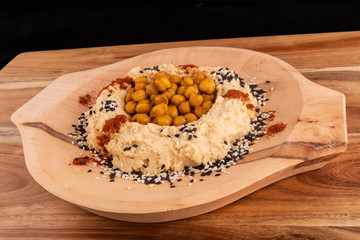 Fried or oven roasted chickpeas and hummus paste spiced turmeric curcuma