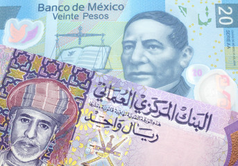 A close up image of a one Romanian leu bank note with a blue twenty peso Mexican bank note in macro