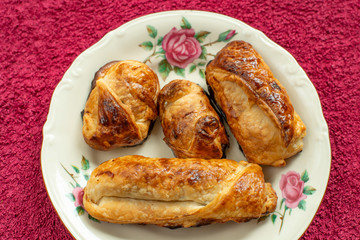 Four nicely browned homemade pastries (pains au chocolat)
