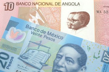 A colorful ten kwanza bill from Angola with a blue, Mexican peso bank note close up in macro