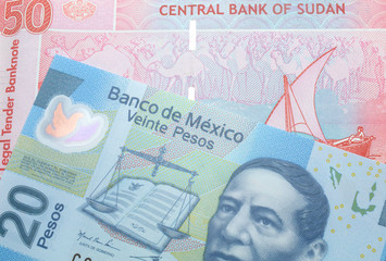 Fototapeta premium A twenty Mexican peso note with a fifty pound note from Sudan close up in macro