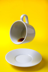 cup of coffee floating on a yellow background