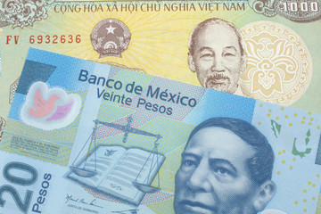 A colorful thousand dong note from Vietnam close up in macro with A blue, twenty Mexican peso note