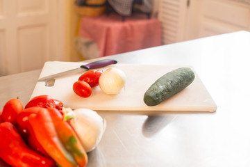 Fresh vegetables on a table with knife - vegan food - salad, healthy food - stainless steel table with food