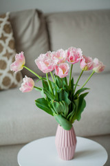 Bouquet of pink tulips in a vase in a home interior