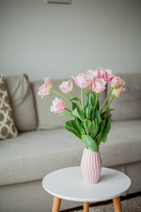 Bouquet of pink tulips in a vase in a home interior