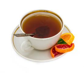 White cup with tea and a spoon and marmalade on a white saucer. View from above
