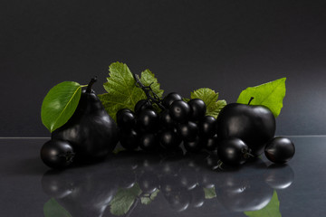 Black fruits on gray background